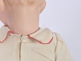 a close up of a doll ' s head wearing a shirt and tie