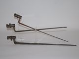two metal tools that are sitting on a white surface
