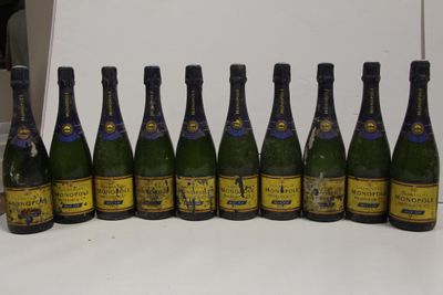 bottles of wine lined up in a row on a counter
