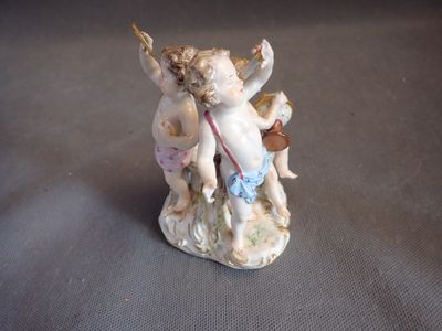 a figurine of a cupid with a bow on it