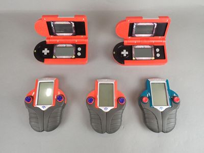 four nintendo game consoles sitting next to each other on a table