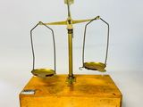 an old brass scale with two balance bars on it