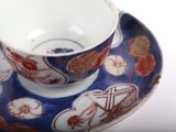 a cup and saucer sitting on a saucer on a table