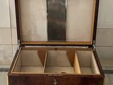 a wooden box with compartments on a glass table