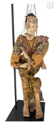 statue of a man sitting on a stool holding a guitar