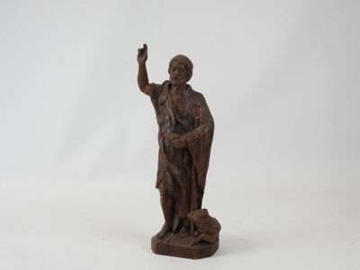 an old wooden statue of a man holding a bird on a white background