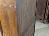 a wooden cabinet with a black top in a room