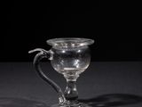 a glass cup that is sitting on a table