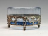 a glass bowl with a blue base on a stand