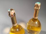 two bottles of wine sitting next to each other on a table