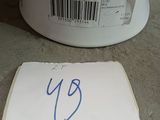 a piece of paper on the ground next to a container of food