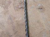 an image of a drill and a screw on the floor