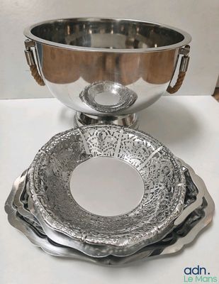 a silver bowl and a silver bowl on a white table