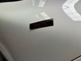 a sticker on the hood of a white car
