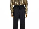 the mannequin is wearing a gold top and black pants