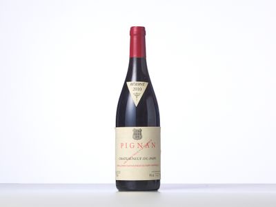 a bottle of red wine sitting on top of a table