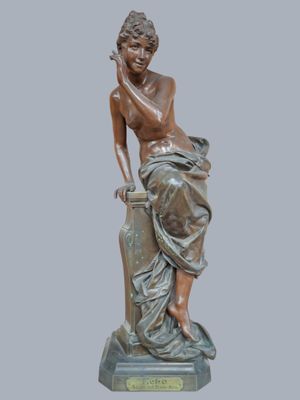 bronze statue of a woman sitting on a rock with her hand on her chin