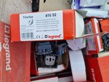 a cardboard box full of electronic gadgets sitting on the ground