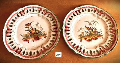 two plates with birds painted on them on a table