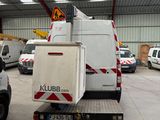 a truck that is parked in a building with other trucks