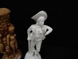 two figurines of a man and a woman standing next to each other