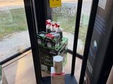 a display case with a lot of sodas on it