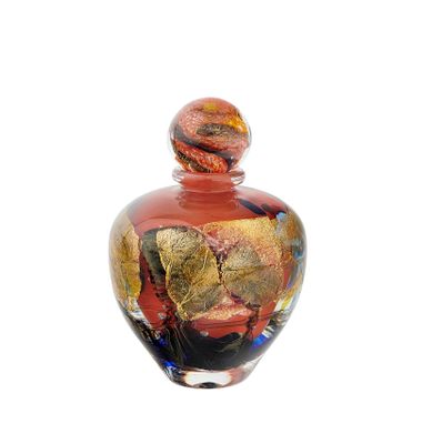 a glass vase with a red and gold design on it