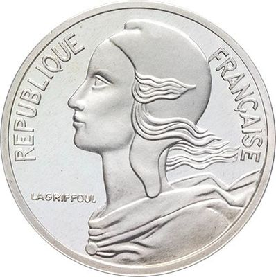 a close up of a coin with a woman ' s face on it