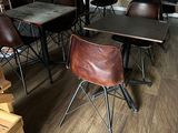many chairs and tables in a room with wood flooring
