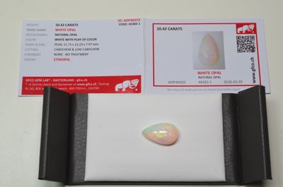 a white oplite stone sitting on top of a white table