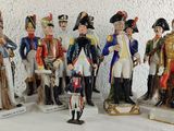 seven figurines of men dressed in military uniforms