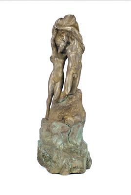statue of a man and a woman embracing on a rock