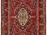 a red rug with a medallion design on a white background