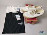 two pairs of shoes, a t - shirt, and a pair of shoes on a table