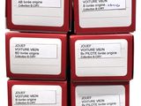 six boxes of red and white labels are stacked on top of each other