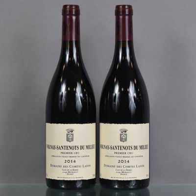 two bottles of wine sitting on top of a table next to each other