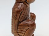 wooden sculpture of a monkey sitting on its hind legs
