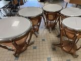 four drums sitting on the floor in a room