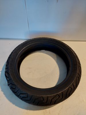 a tire on a white surface with a white wall in the background