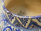 a blue and white vase sitting on a table