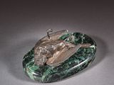 sculpture of a frog on a green marble base