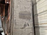 a large piece of wood sitting on a pallet in a garage