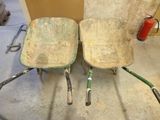 two wheelbarrows sitting next to each other on the floor