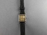 a close up of a wrist watch with a black strap
