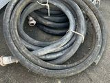 a hose that is laying on the ground next to a truck