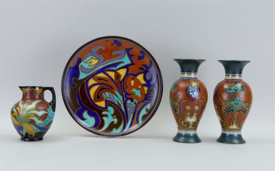 three vases and a plate sitting next to each other