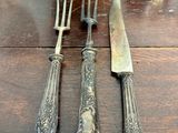 silverware on a wooden table with silverware and silverware in the background