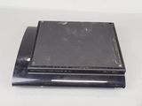 a black electronic device sitting on a white table