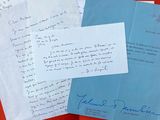 several letters are sitting on top of a red table