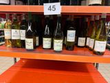many bottles of wine on the shelves in the store